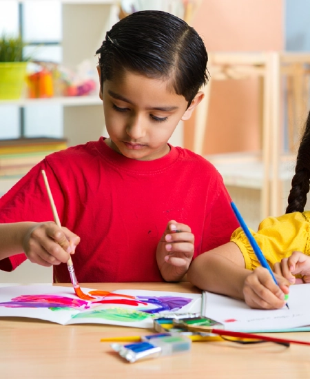 Boy painting with brush