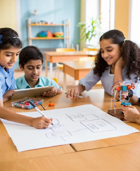 Children sketching technical diagrams